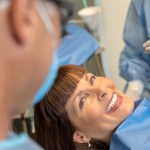 a smiling lady showing her teeth after a periodontal service