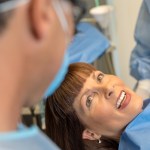 a lady showing her teeth to a dentist